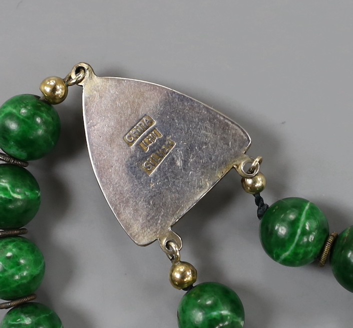 A 20th century Chinese single/double strand malachite bead necklace, with white metal clasp and triangular motifs, stamped 'China Liu Silver', 67cm.